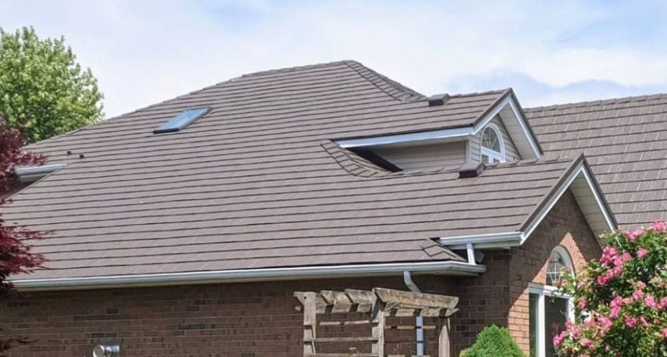 Aerial view of a newly installed stone-coated metal roof